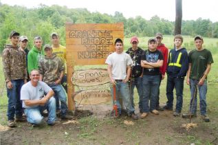 Granite Ridge's SHSM teacher Shawn Lavender with grade nine students at the school’s newly completed nursery project